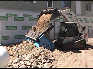 Rntal SLG-78 and skid steering dumping material for screening.